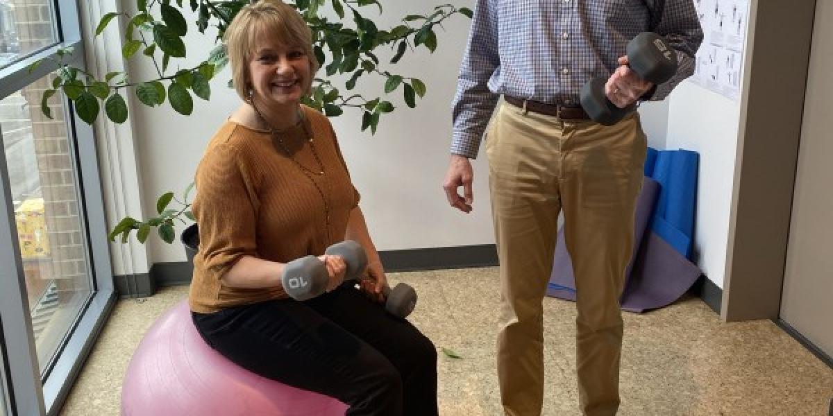 two people with exercise weights