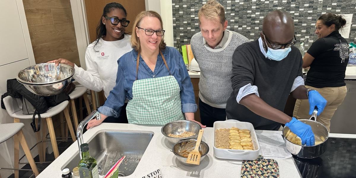 four people preparing food