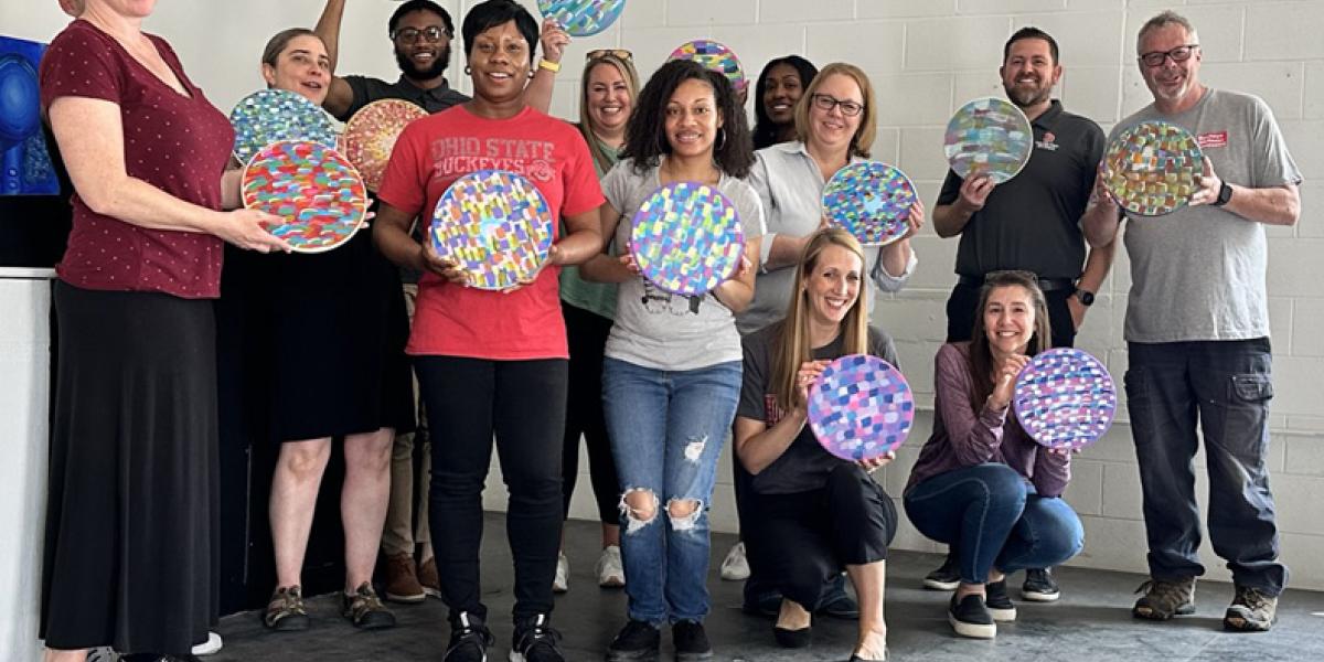 group photo with people displaying art