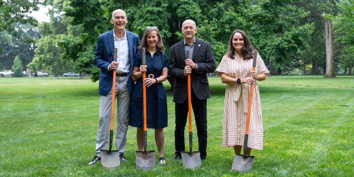 Jay Kasey, his wife, Mark Conselyea and Amy Burgess holding shovels.