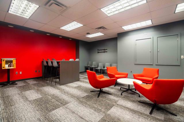 Photo of a lobby with red lounge chairs and other furniture