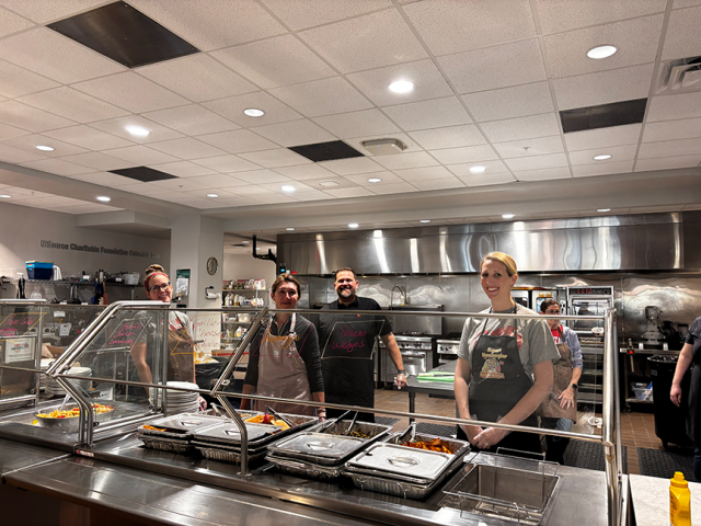 team standing in a kitchen
